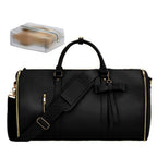 Black duffel bag with gold accents on a white background