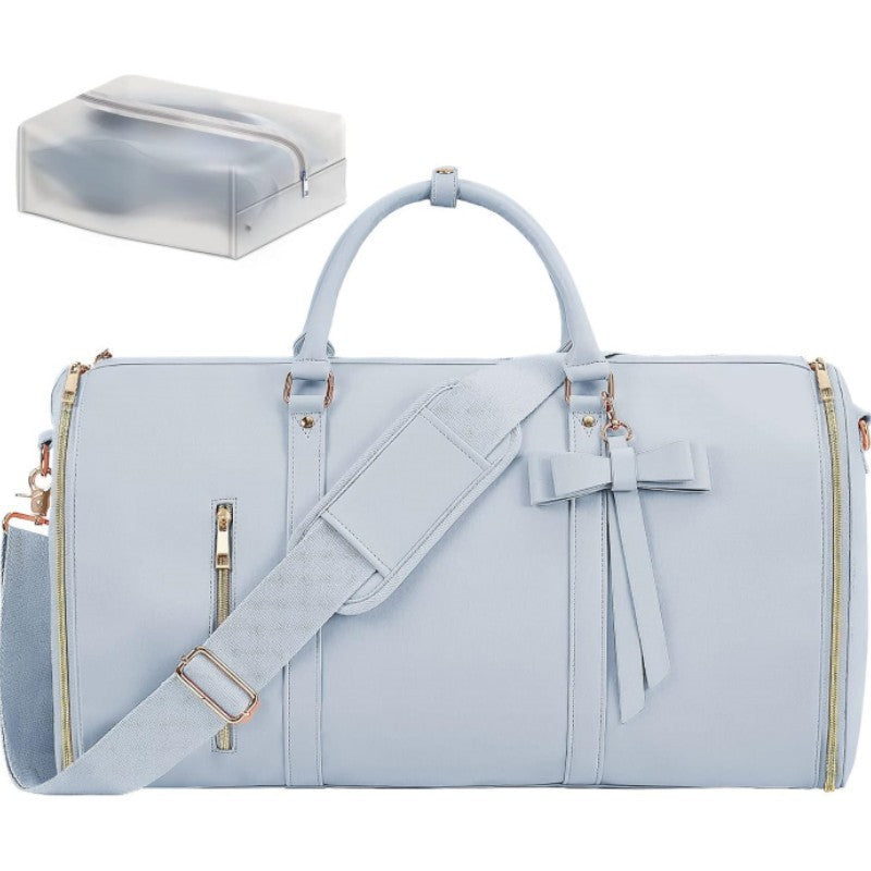 Light blue duffel bag with a bow and gold accents on a white background
